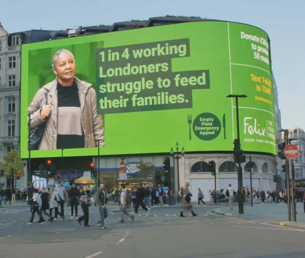 Felix Project Empty Plate Emergency Appeal on the curved Piccadilly Circus screen above crowds