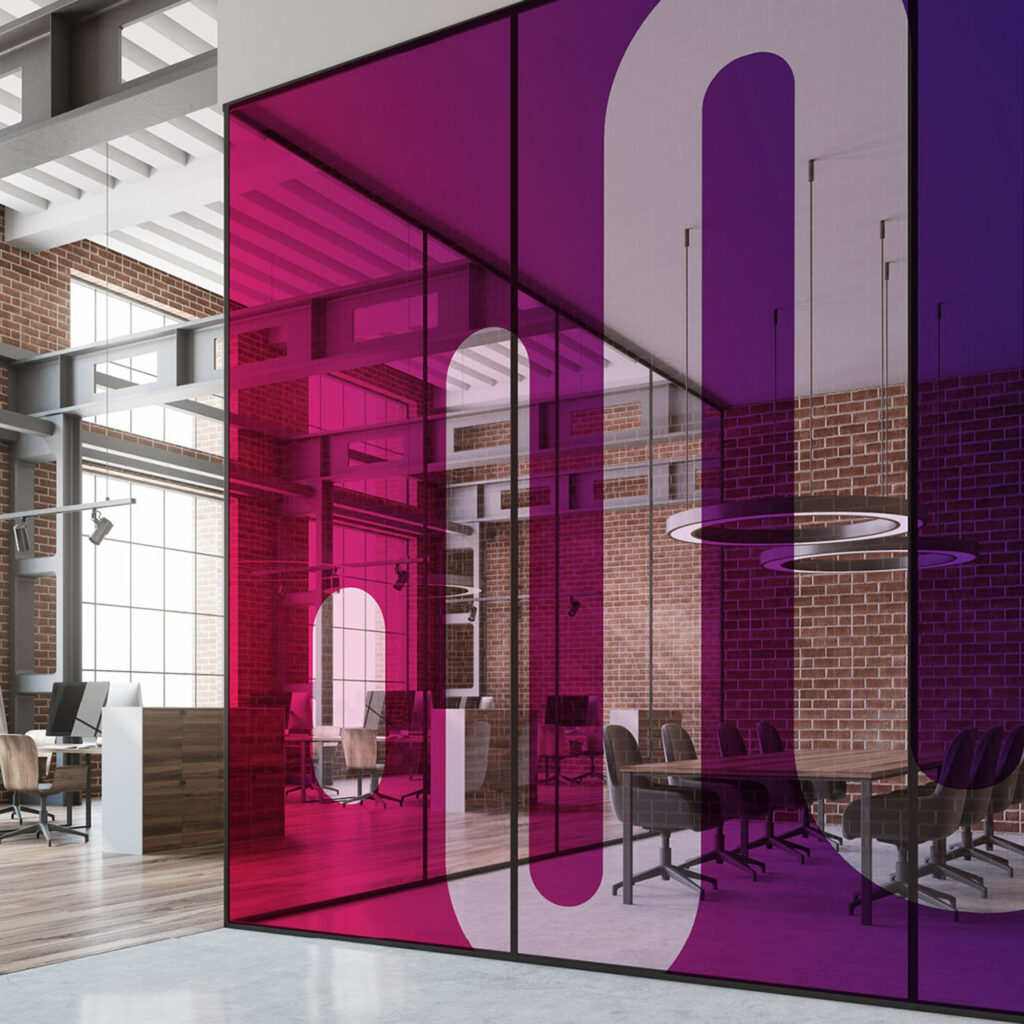 An office meeting room behind glazing printed with oversized Mortgage Brain logo shapes in pink and purple.