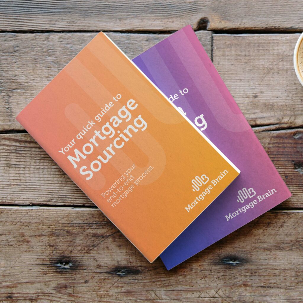 Two Mortgage Brain quick guide brochures on a wooden table, one orange and one purple, titled "Your quick guide to Mortgage Sourcing".