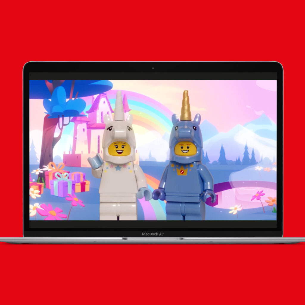 The Unicorn party film playing on a laptop, showing two LEGO minifigures in unicorn costumes